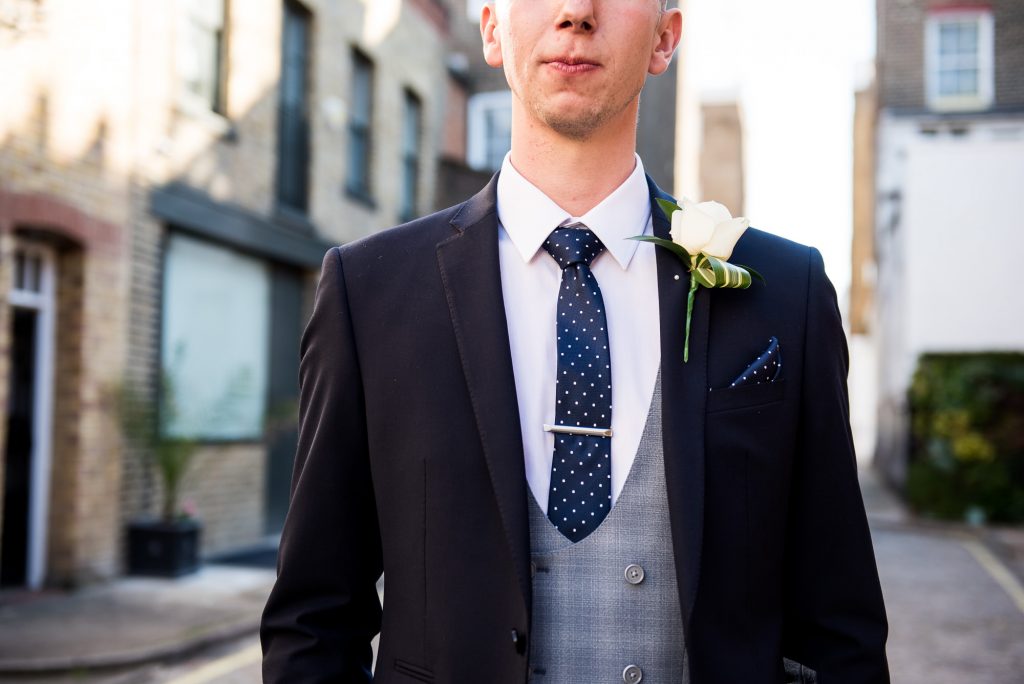 Old Marylebone Town Hall Wedding, handsome groom in three piece navy blue suit with grey waistcoat