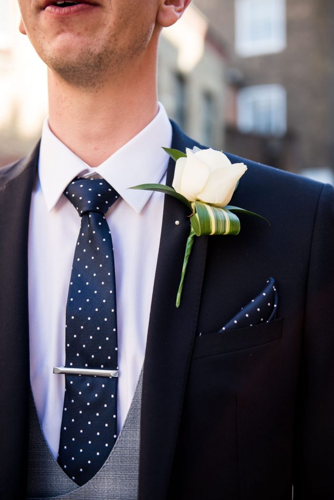Old Marylebone Town Hall Wedding, stylish single white rose buttonhole