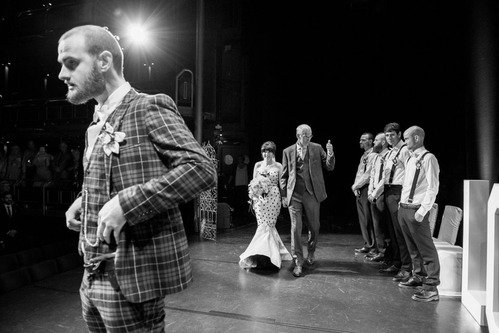 Arriving on stage to be married in a theatre © Jessica Grace Photography