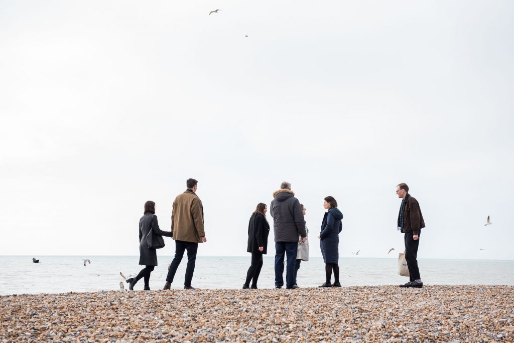 LGBT wedding photography, family walk on Brighton beach together
