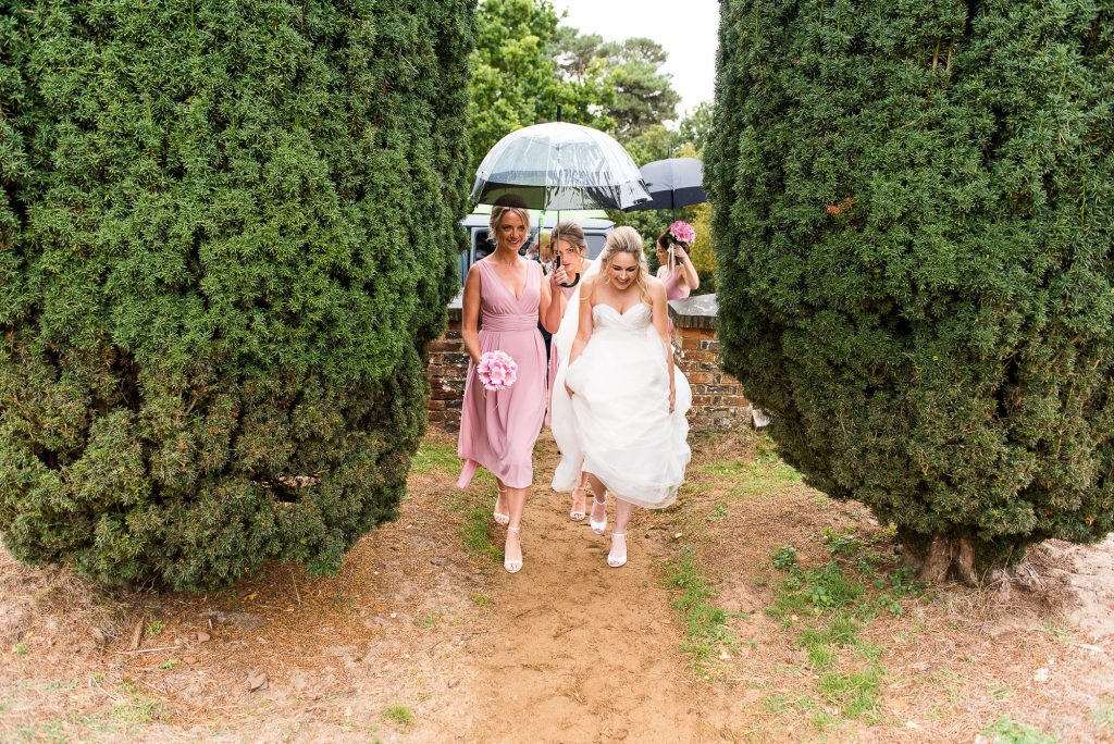 st martha's wedding, bride gets helping hand to the ceremony from her bridesmaids