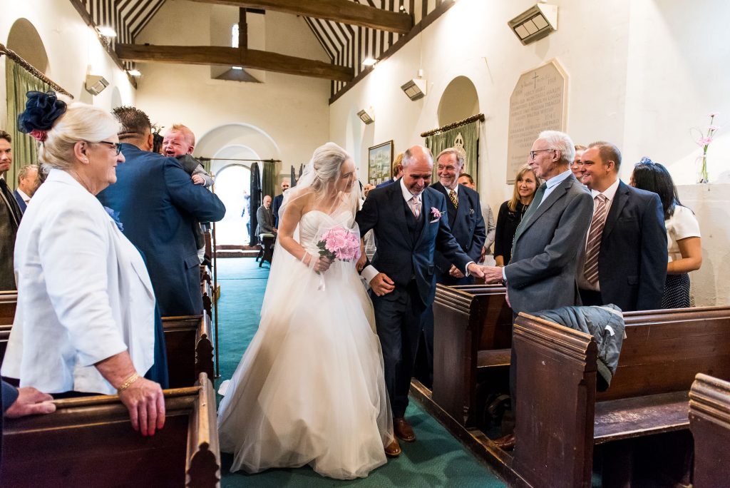 st martha's wedding, bride and father walk together down the aisle