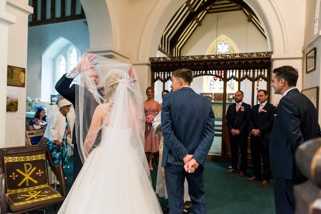 father of the bride takes off his daughters veil