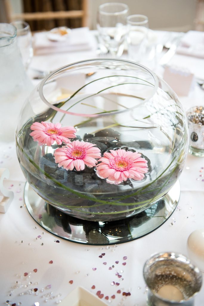 pink flowers floating in water feature