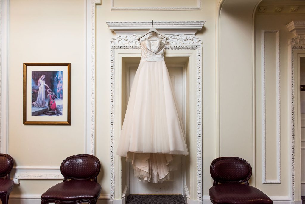 wedding dress hanging on the door at Horsley Towers