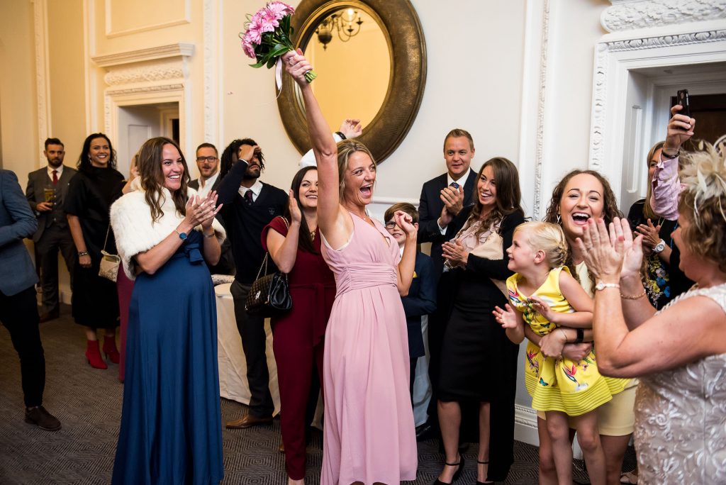 bridesmaid shows the bouquet in a celebration