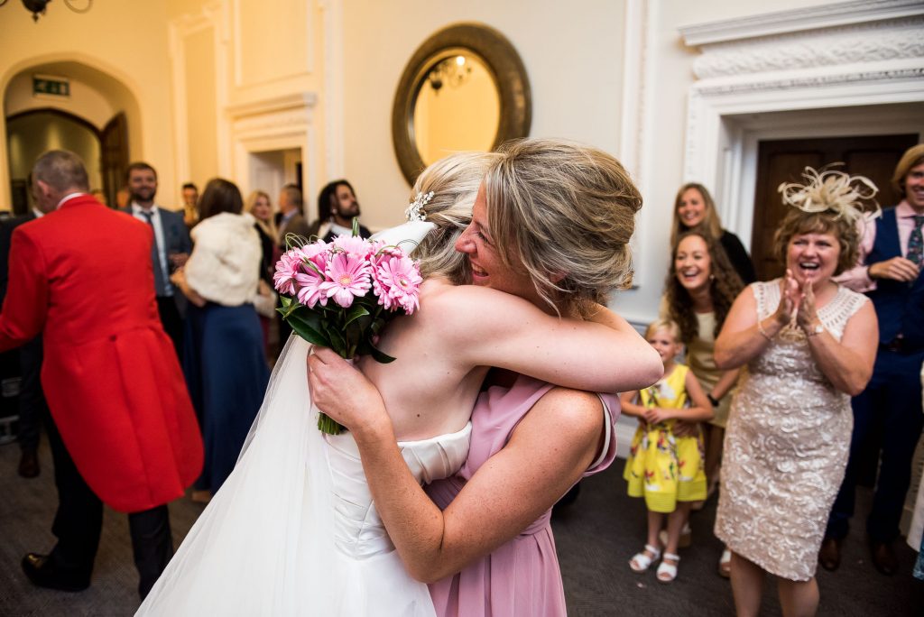 bride and maid of honour embrace