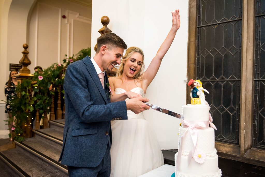 Horsley Towers wedding couple celebrate cutting the cake