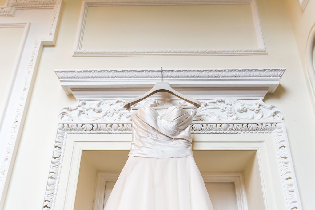 wedding dress hanging on the door at Horsley Towers