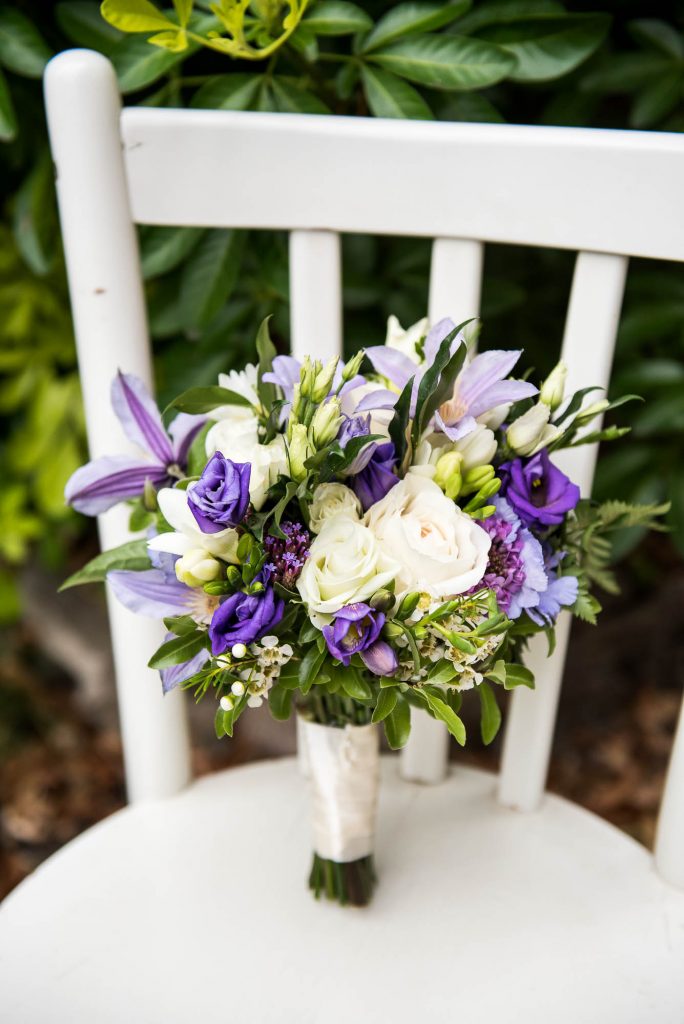 Wedding bouquet with green, white and purple floral arrangements