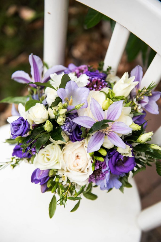 Wedding bouquet with green, white and purple floral arrangements