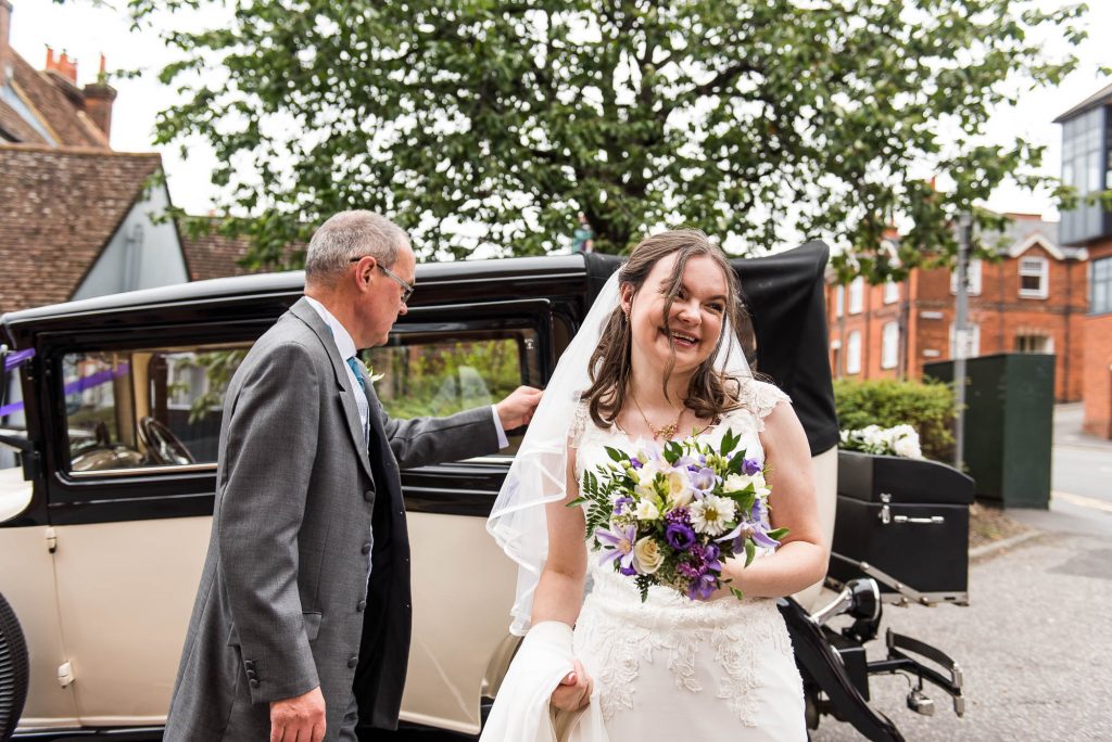 Bride arrives for Surrey wedding with her parents