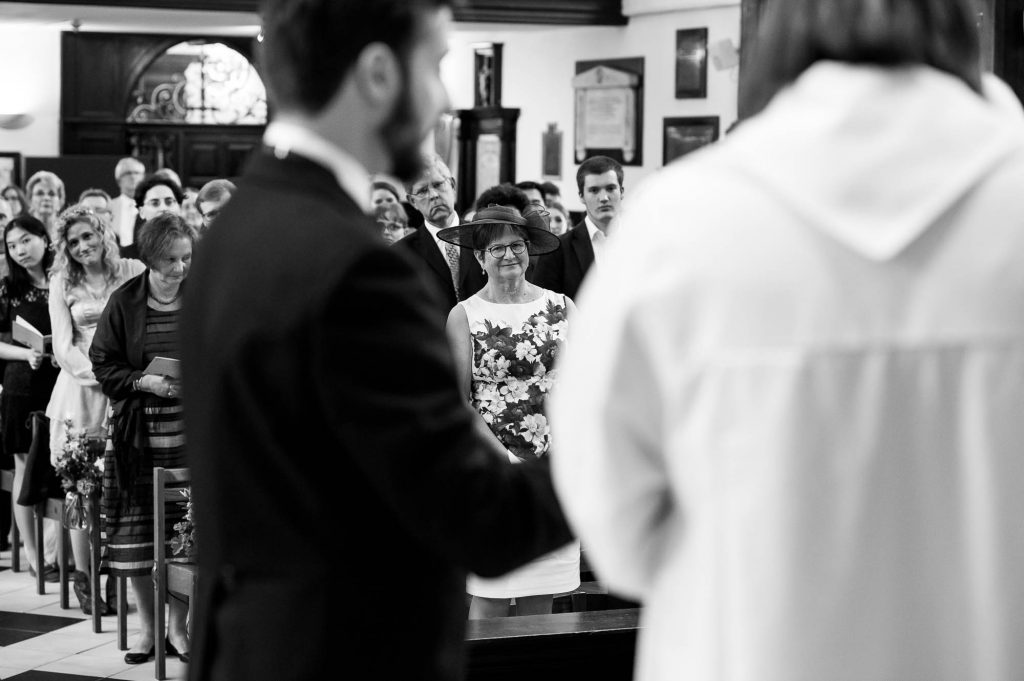Black and white image of mother watching her daughter get married