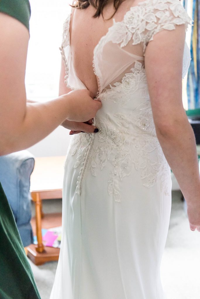 Surrey bride has lace buttons done up
