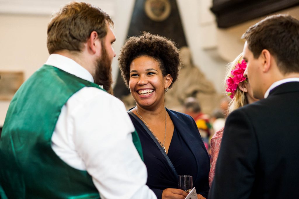 Beautiful woman smiles candidly during drinks reception