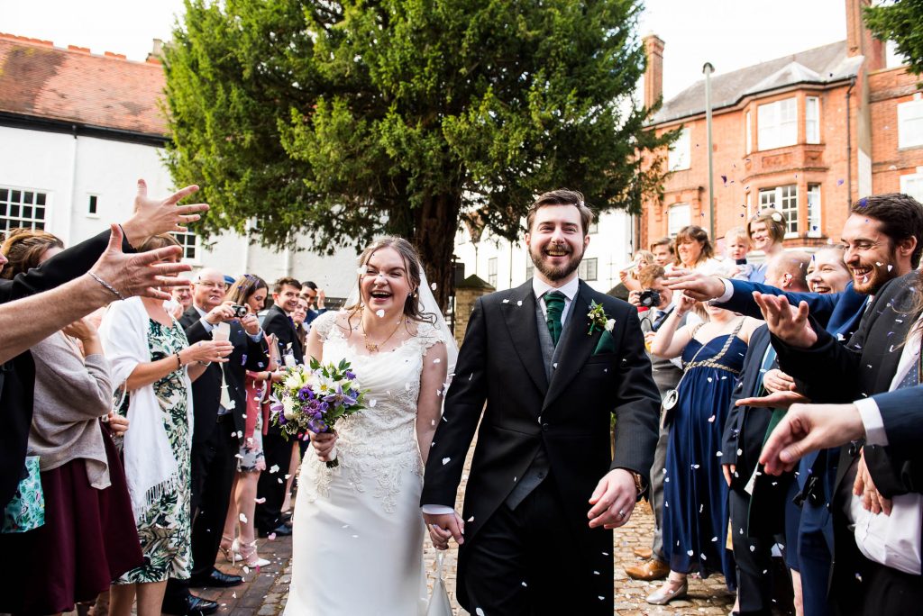 Confetti is thrown over the happy couple at St Mary's church in Guildford
