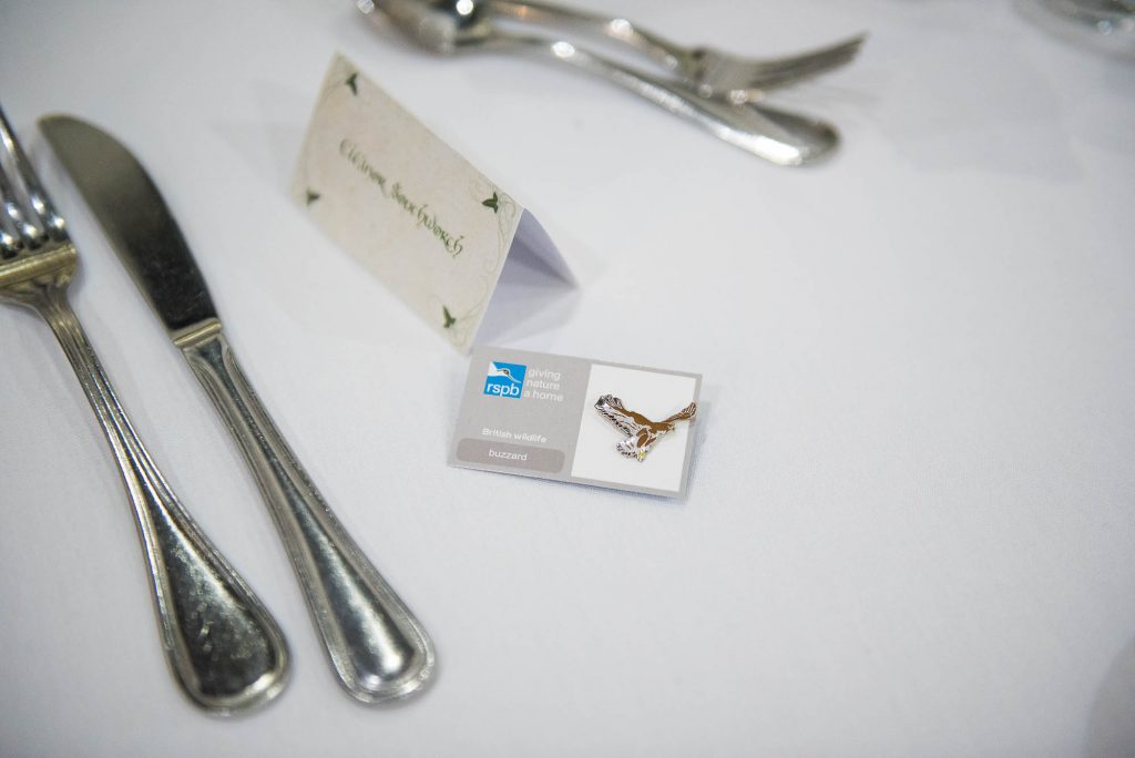 Wedding favours for guests consisting of badge pins of charities 
