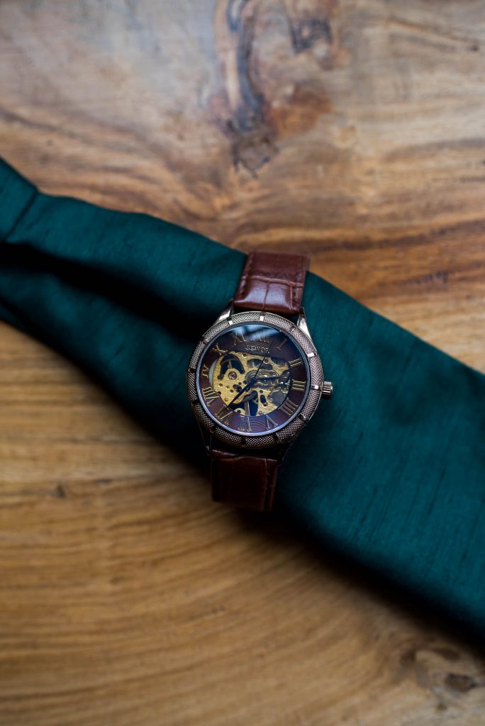Wedding details - A Rustic watch is wrapped around a wedding pocket square