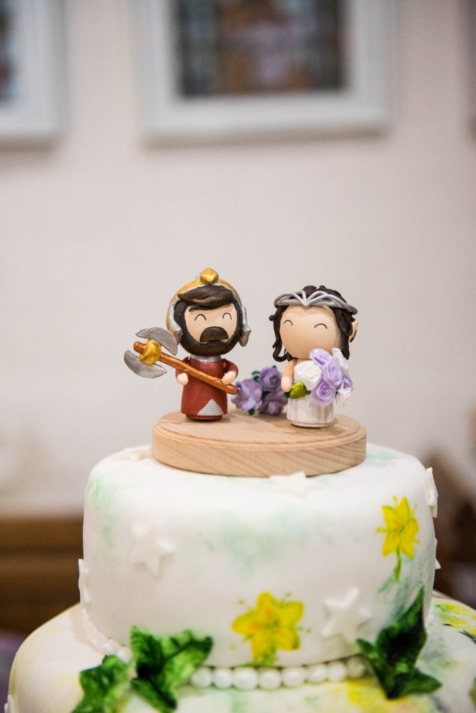 Elven figurines stand atop wedding bespoke wedding cake