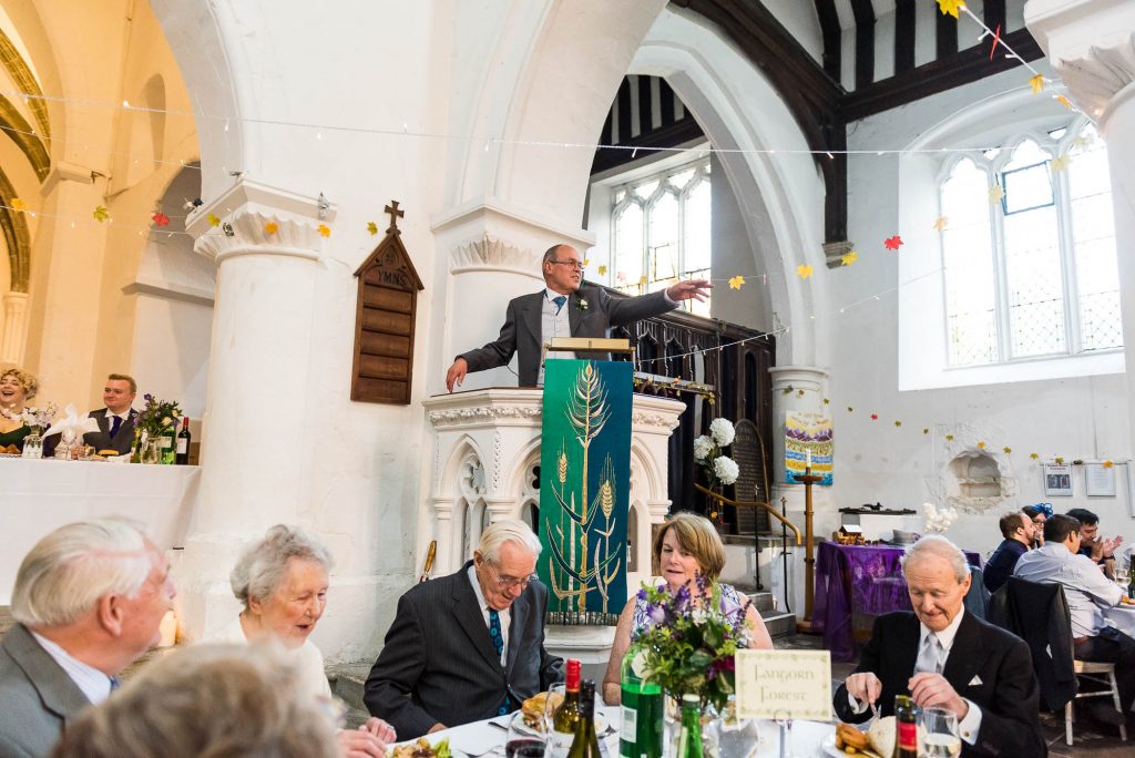 Vicar gives a speech to say grace before the wedding breakfast