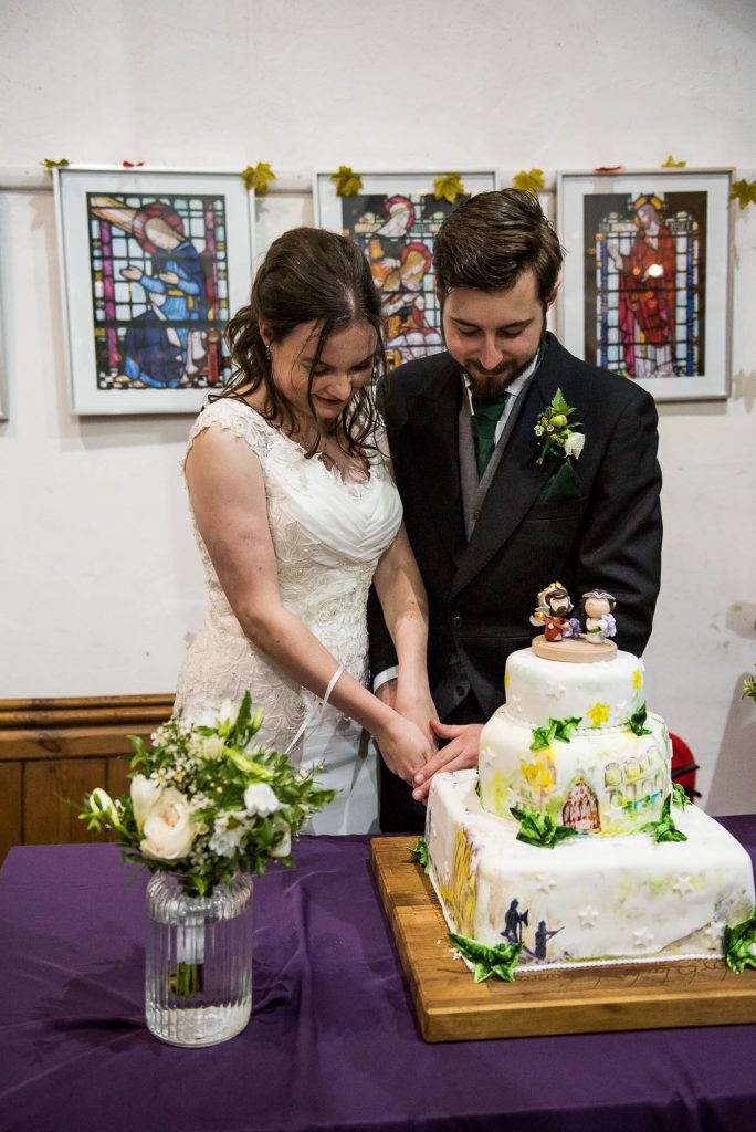 Couple cut the Lord of the Rings themed wedding cake together