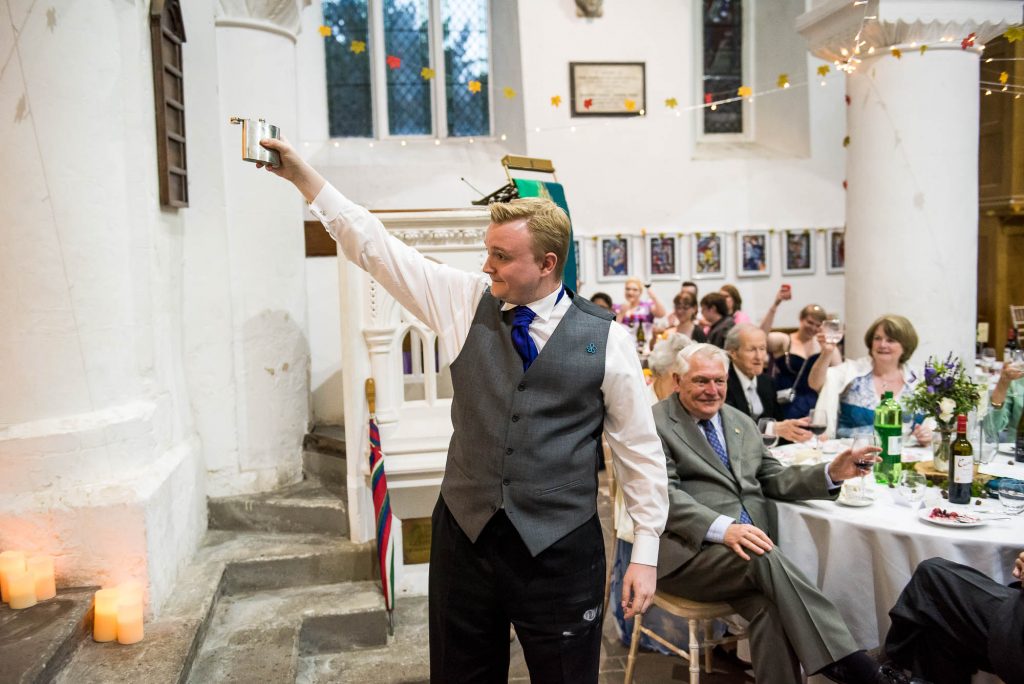 Best man raise a toast, Documentary wedding photographer surrey