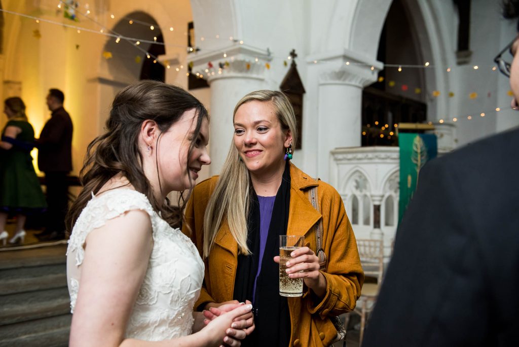 Documentary wedding photographer surrey, Guests chat candidly with the bride