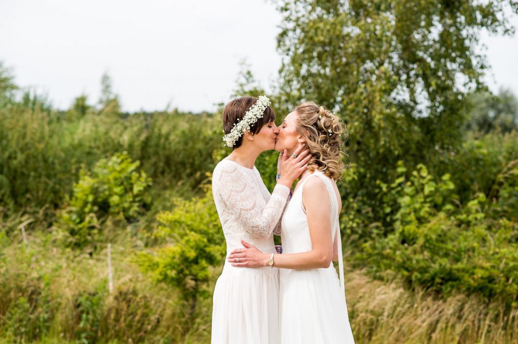 natural wedding phootgraphy // same sex couple kiss passionately 