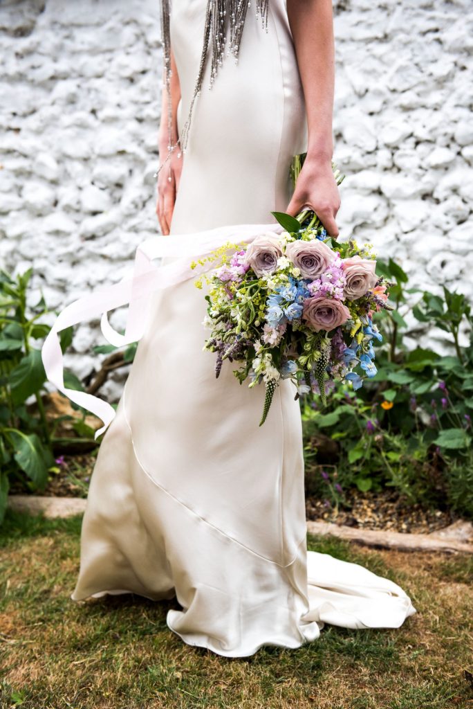 Surrey bride in a silk Pantiles wedding dress holding pastel coloured bouquet