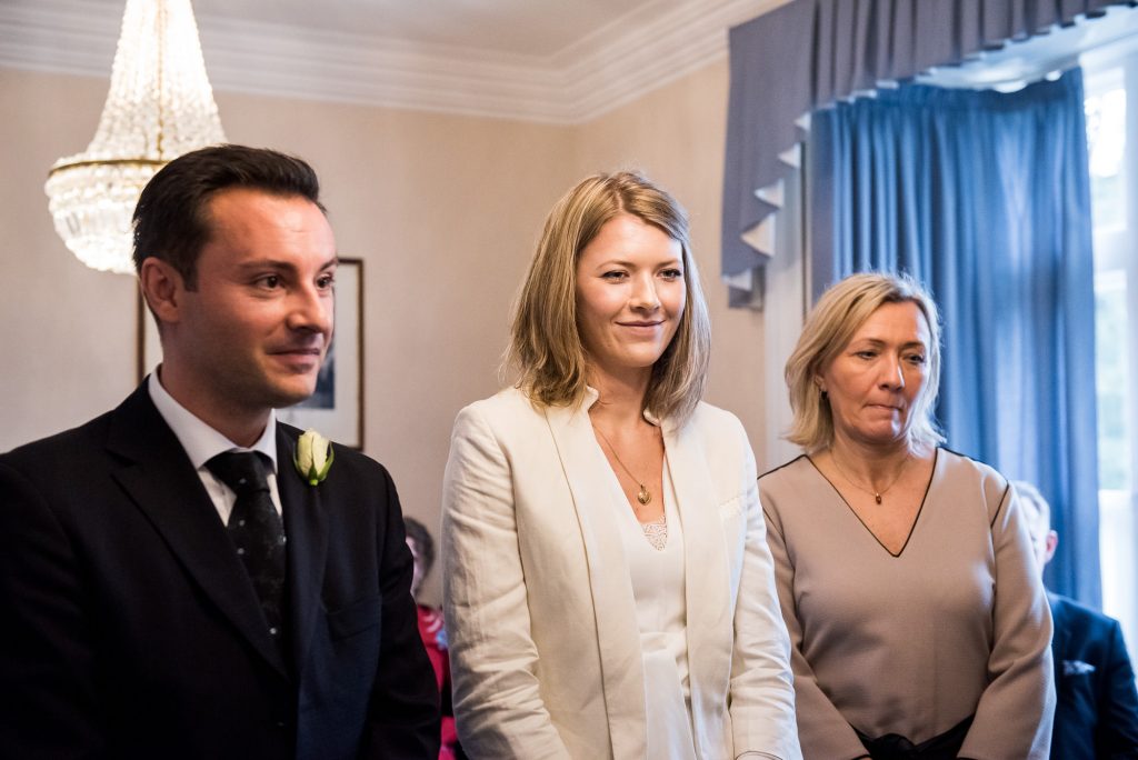 Smiling bride stands with her family at ceremony Artington House wedding