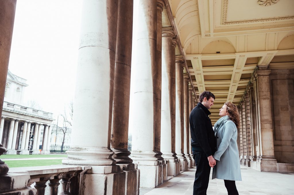 Couple stand looking at each other at Greenwich Naval College