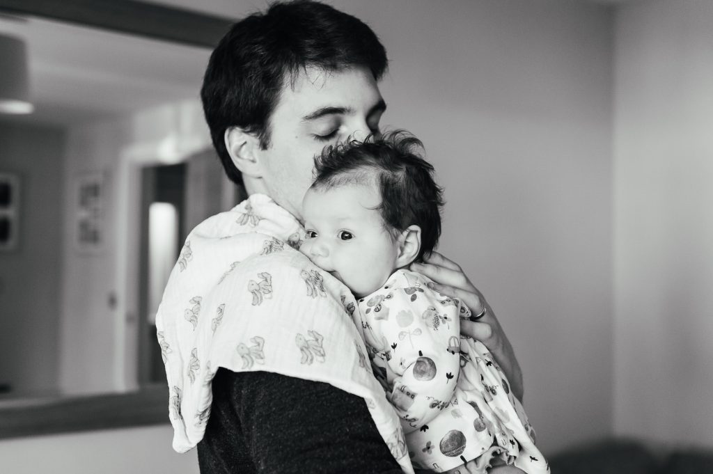 Baby rests on fathers shoulders in Hertfordshire family photography shoot