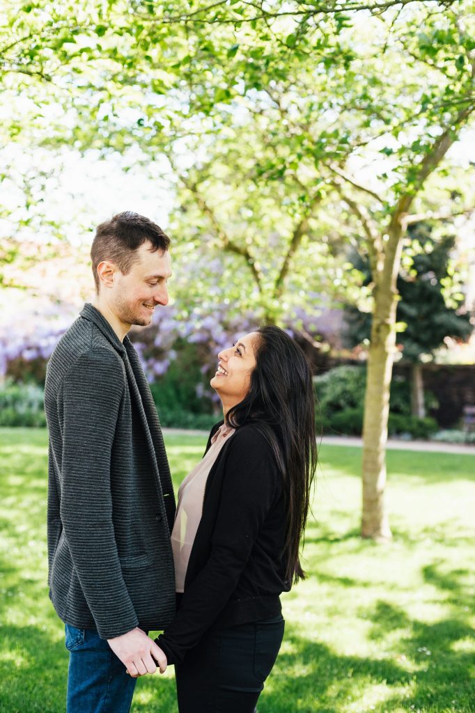Forty Hall engagement photography - couple smile and stare at each other on London engagement shoot