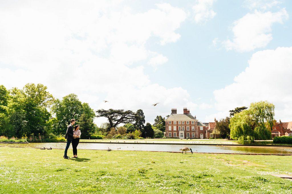 Engaged couple standing in the grounds of Forty Hall