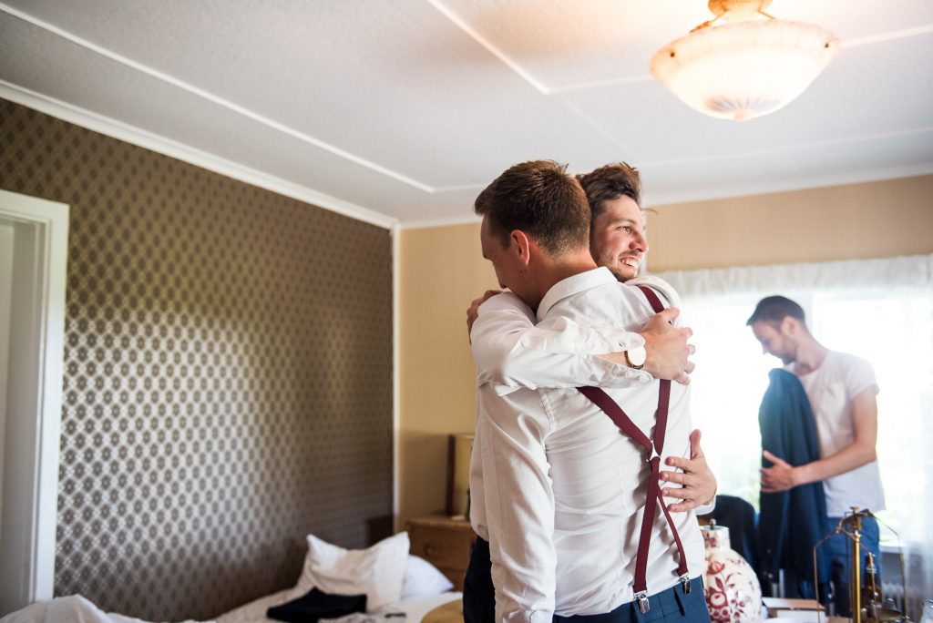 groomsmen hug each other, documentary wedding photography