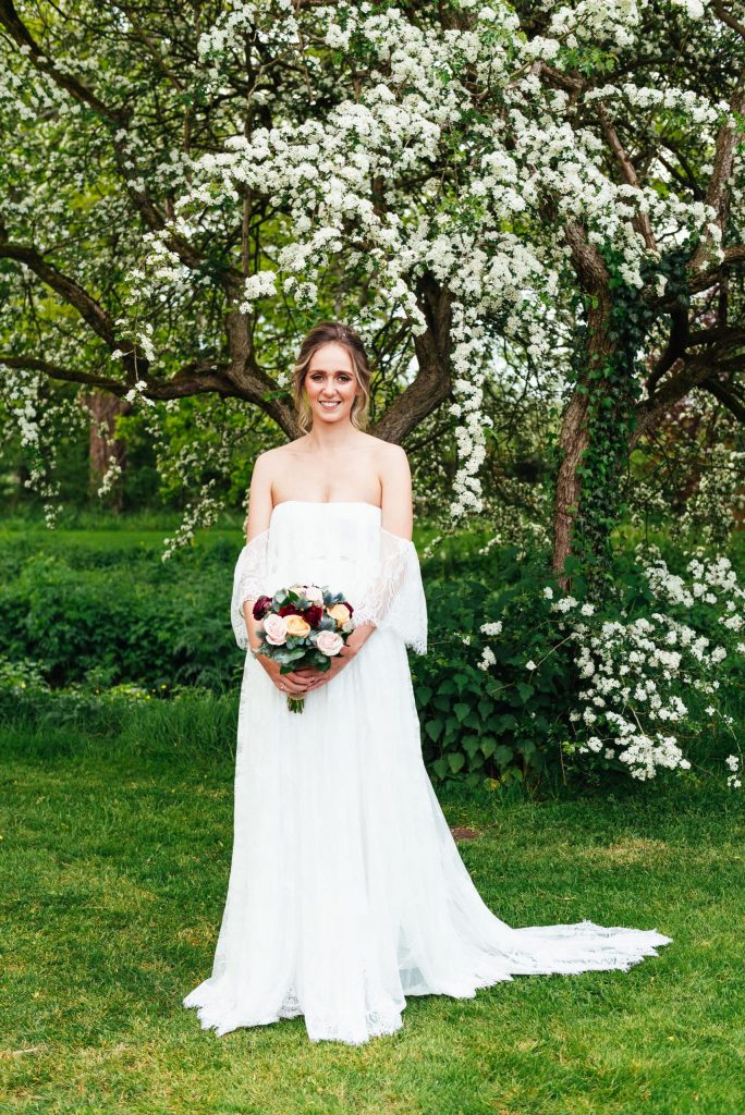 Beautiful bride in a strapless Grace Loves Lace wedding dress