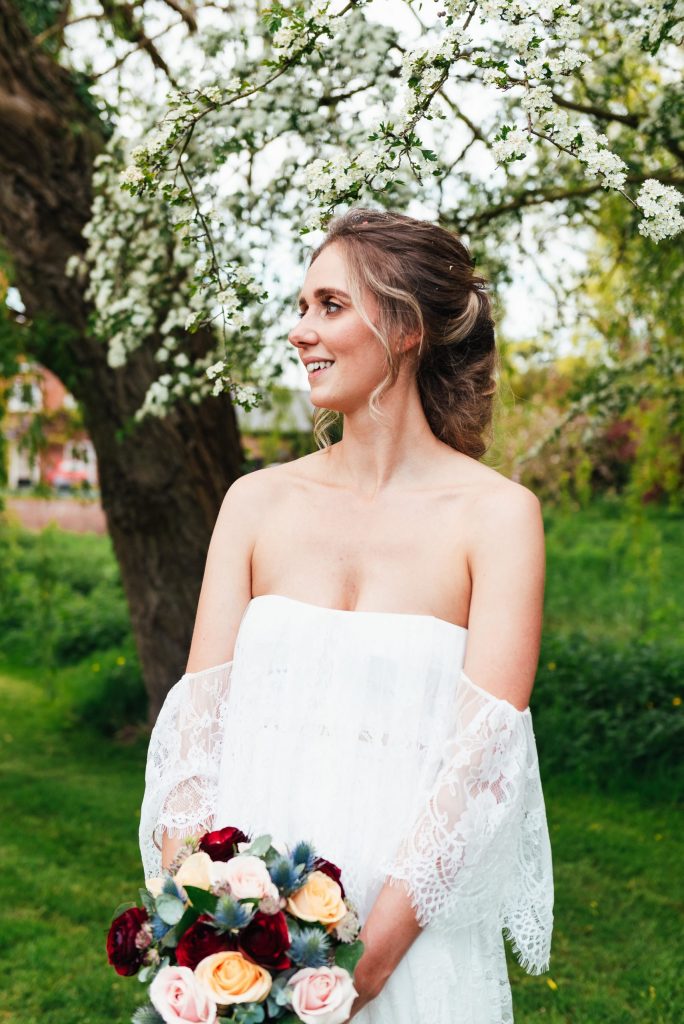 Beautiful bride in a strapless Grace Loves Lace wedding dress