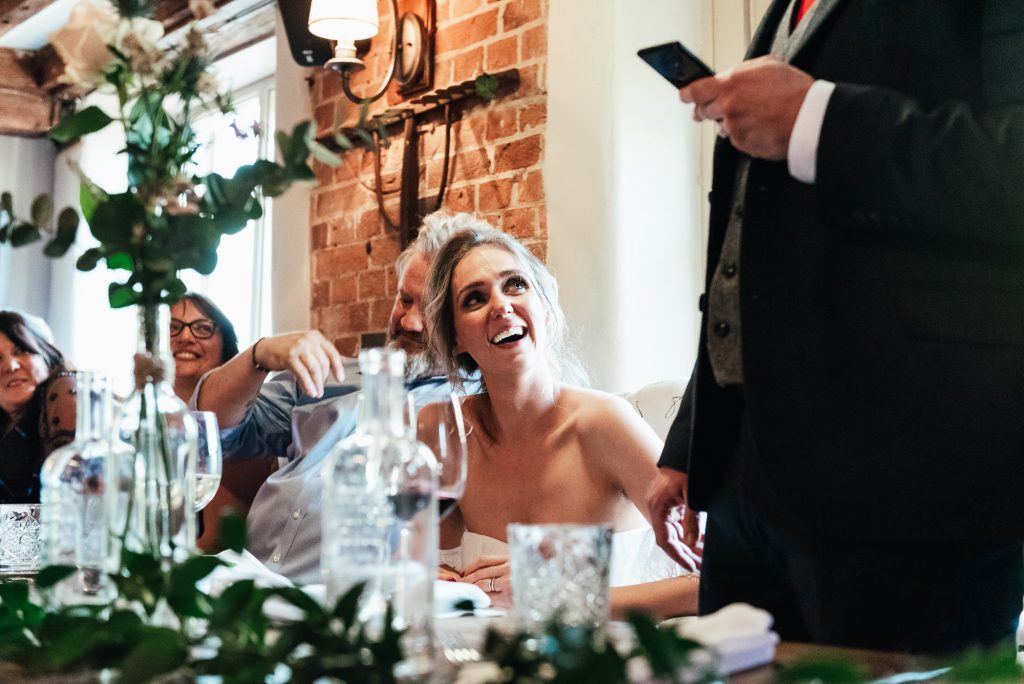 Smiling bride looks up at her husband adoringly