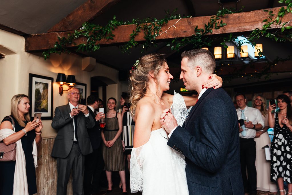 Couple share their first dance both looking adoringly into each others eyes