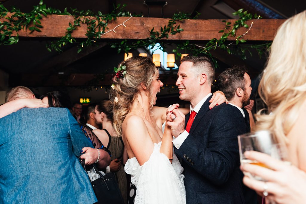 Couple share their first dance, the bride has the most excited look on her face