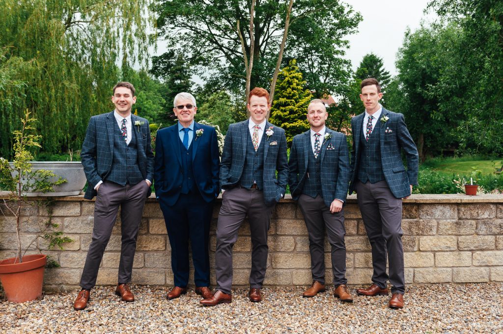 Groomsmen in matching miss matched suits