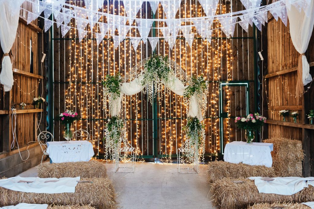 Fairy light backdrop with foliage flower arch, Deepdale Farm Barn wedding