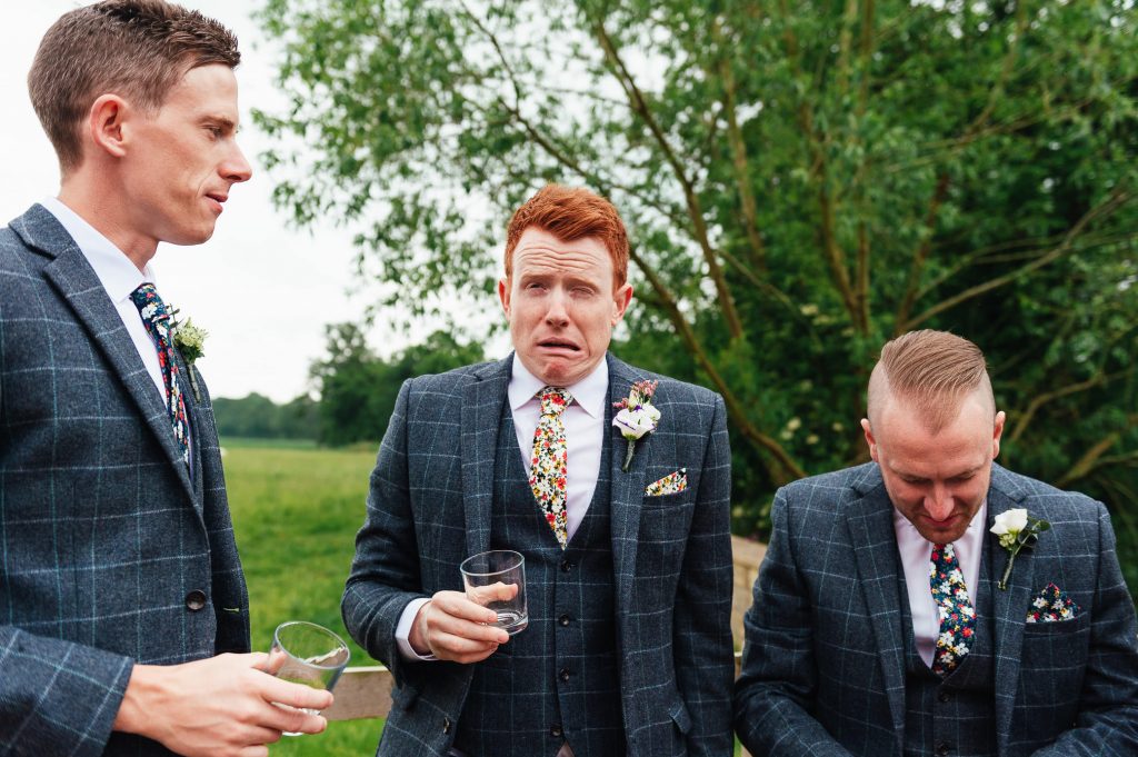Groom pulls a face after whiskey shot