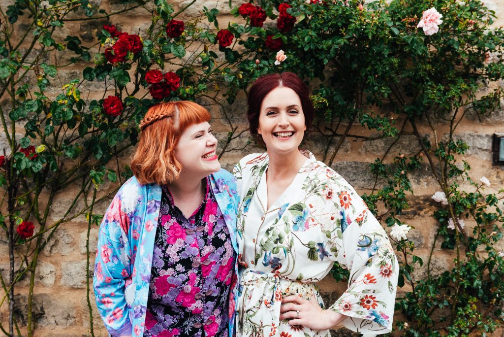 Bride and her maid of honour in matching floral robes