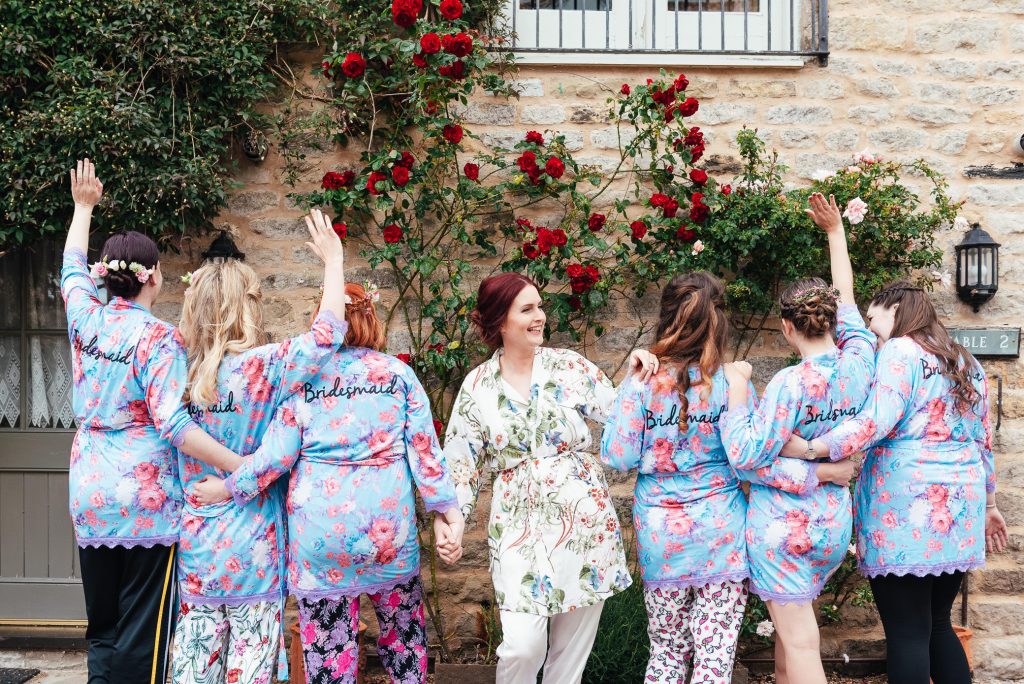 Bridesmaids and bride in matching floral dressing gowns