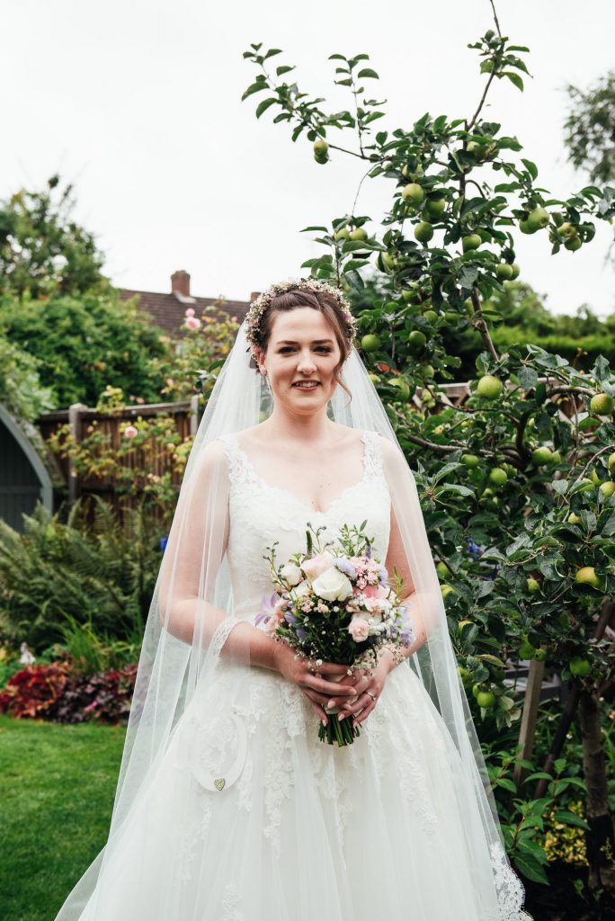 Beautiful bridal portrait in summer English garden