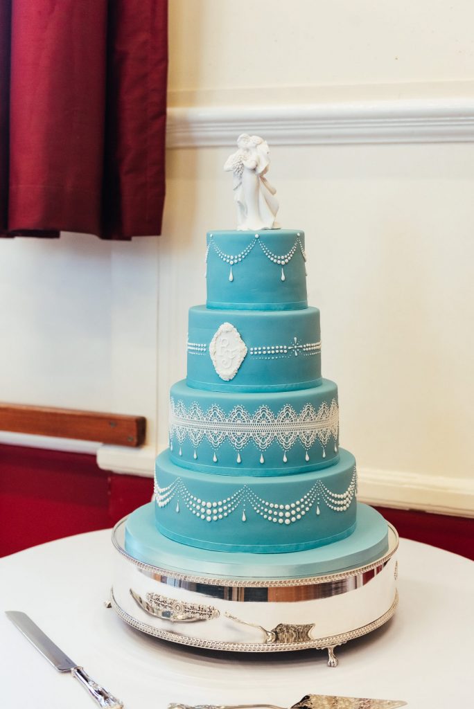 Beautiful embroidered wedding cake with blue icing