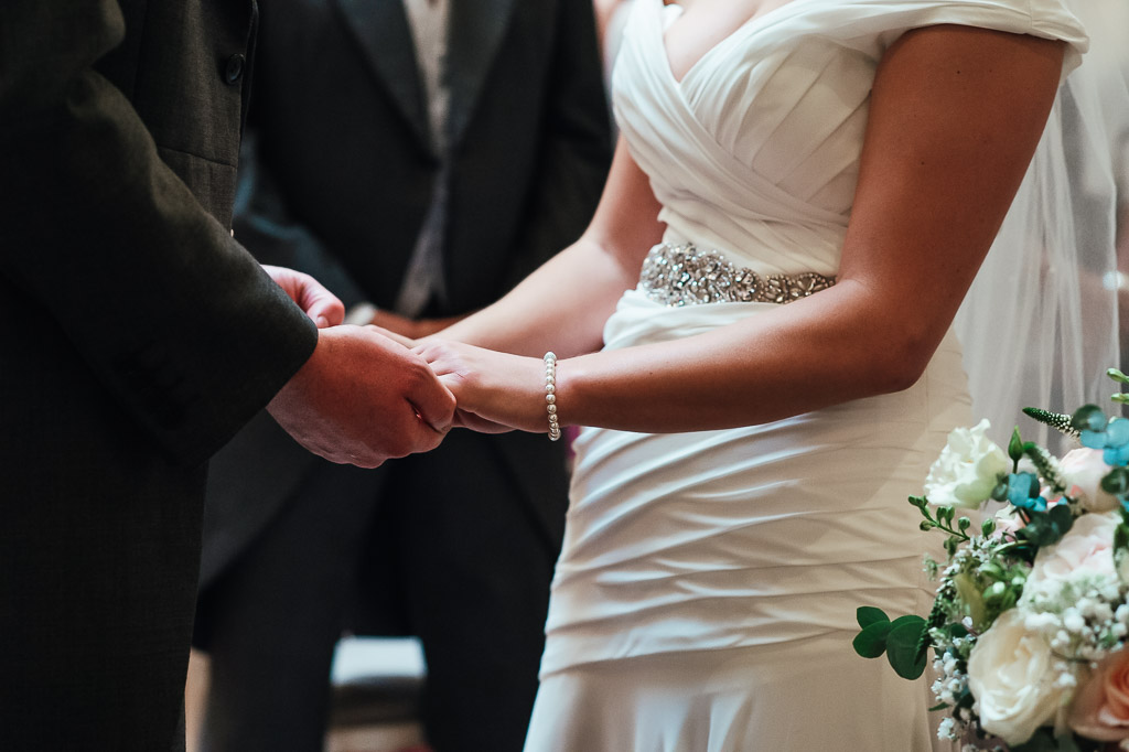 Bride and groom hold hands