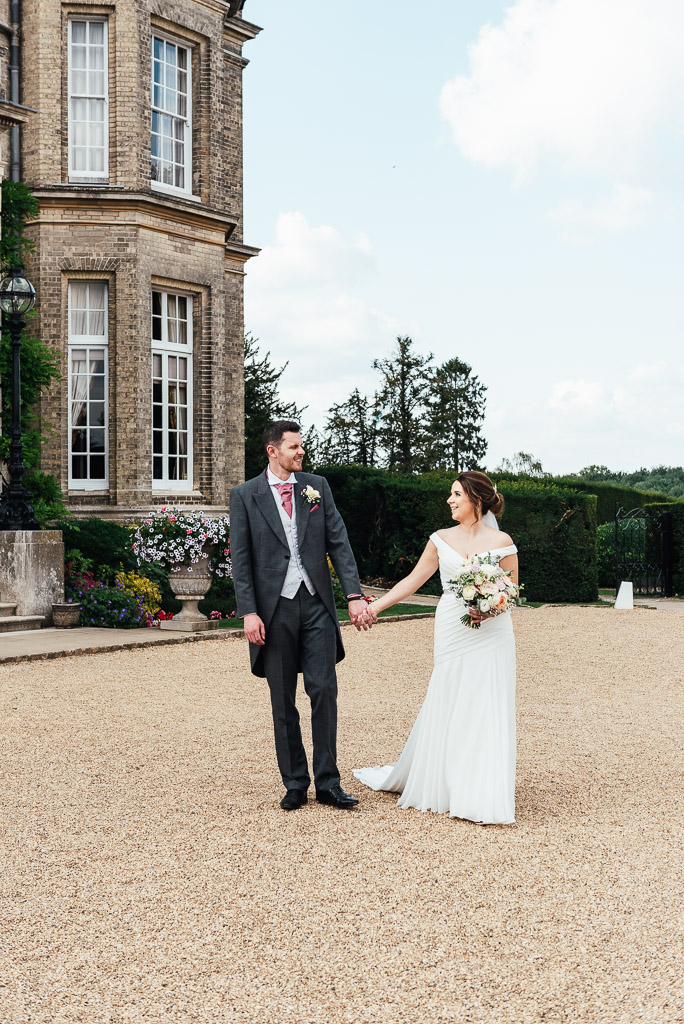 Relaxed couples portrait walking together in the grounds of Hedsor House
