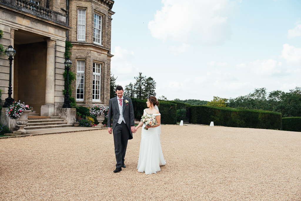 Relaxed couples portrait walking together in the grounds of Hedsor House